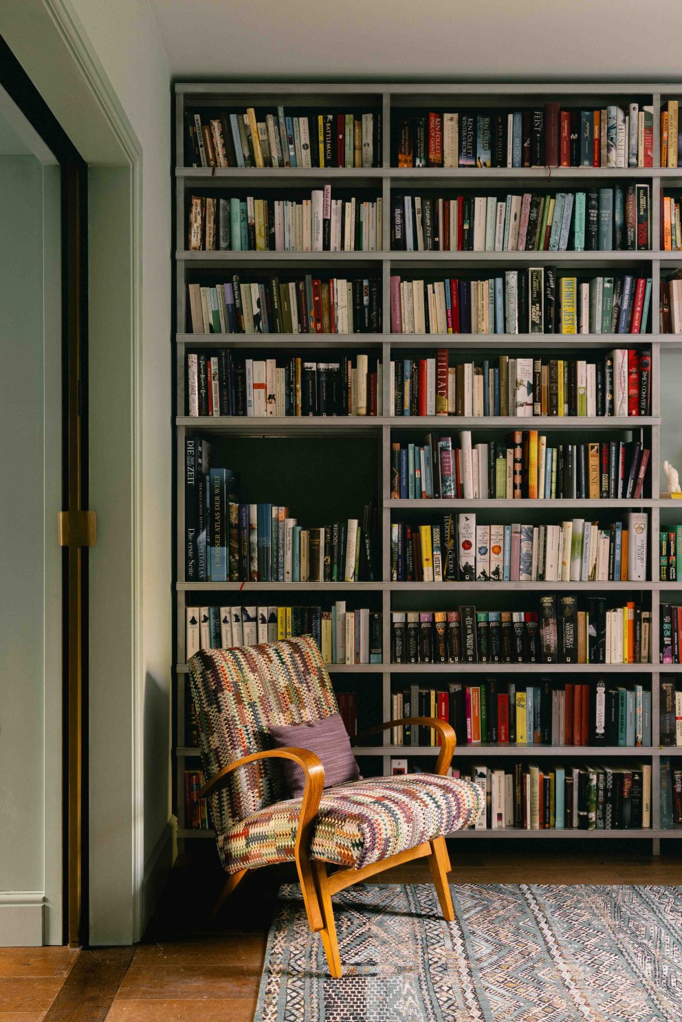 Victorian Terrace, Waterloo | bespoke metal bookcase houses the clients book collection | Interior Designers